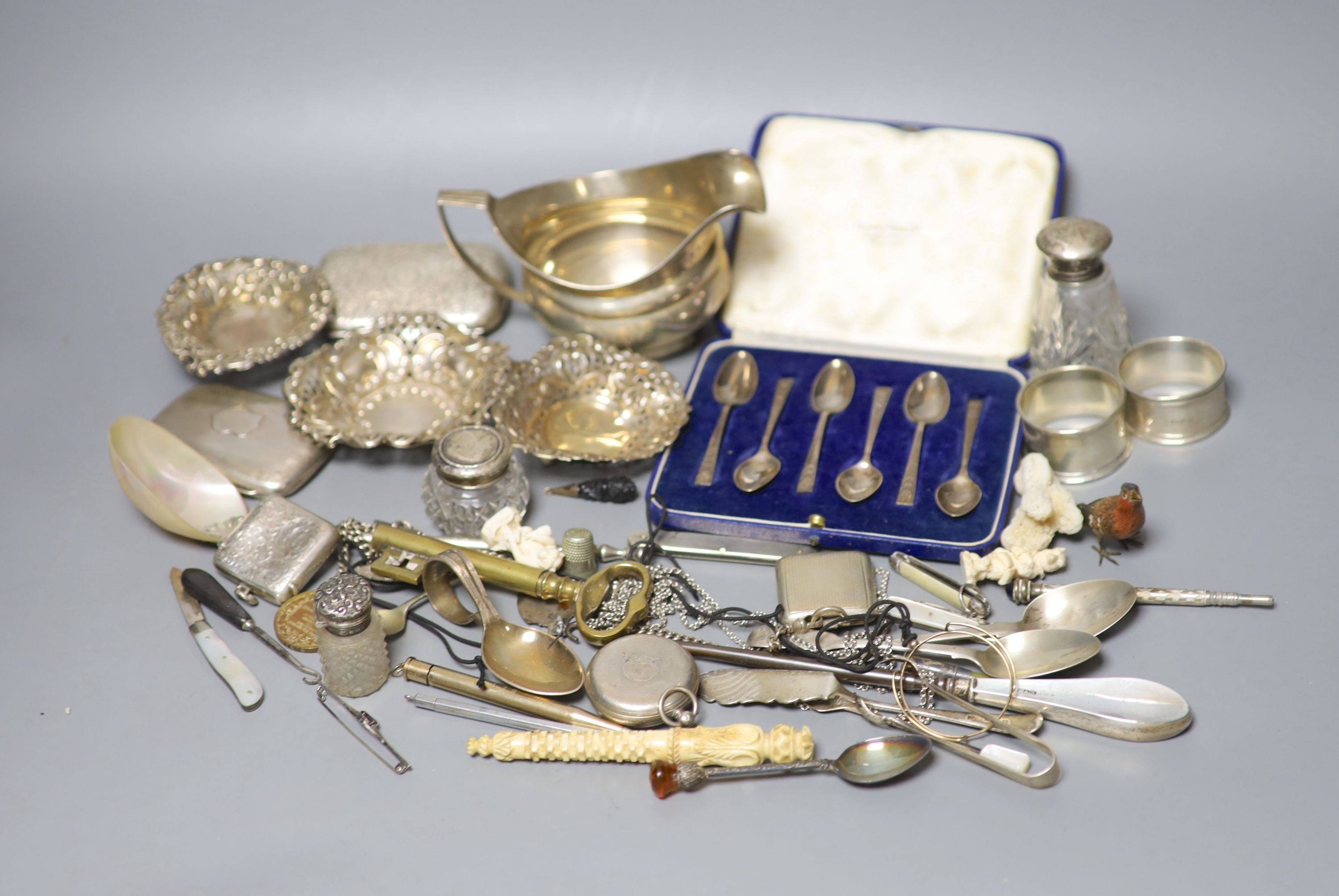 Mixed small silver and other collectable including a cased set of silver silver coffee spoons, a George III silver cream jug, bonbon dishes, cigarette cases, vesta case, flatware, scent bottles, a cold painted bronze bir